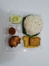 A dish from Indonesia which contains white rice, fried tempeh, fried tofu, fried chicken with delicious chili sauce Royalty Free Stock Photo