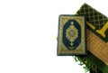 Photos of the Koran and prayer rugs ready for Ramadan.  Arabic on the cover is translated as the Qur'an Royalty Free Stock Photo