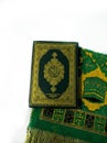 Photos of the Koran and prayer rugs ready for Ramadan.  Arabic on the cover is translated as the Qur'an Royalty Free Stock Photo