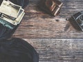 Photos and old camera on old wooden background and blue cloth Royalty Free Stock Photo