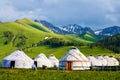 The white mongolia yurts in the high mountain meadow