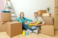 Photos of women and men eating pizza among cardboard boxes Royalty Free Stock Photo