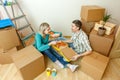 Photos of women and men eating pizza among cardboard boxes Royalty Free Stock Photo