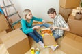 Photos of women and men eating pizza among cardboard boxes Royalty Free Stock Photo