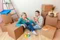 Photos of women and men eating pizza among cardboard boxes Royalty Free Stock Photo