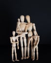 Photos wooden dolls, happy family with children on black background