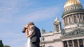 Photosession of a beautiful elegant wedding couple on the background of St. Isaac 's Cathedral. Action. Loving Bride and Royalty Free Stock Photo