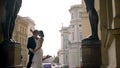 Photosession of a beautiful elegant wedding couple inside the porch of the New Hermitage by the feet of atlantes. Action Royalty Free Stock Photo