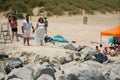 Photoshoot happening in Miami Beach. Female photographer shooting a couple in white