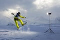 Photoshoot snowboarder who jumps. artificial light from flash