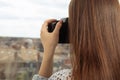 Photoshop for beginners. Learn to take pictures correctly. Girl photographer takes landscape from the window