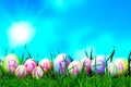 Photoshop Easter Eggs in Sunny Meadow on Blue Sky Background with Italian Sentence Buona Pasqua, that means Happy Easter. Copy