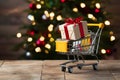 PhotoStock Mini shopping cart with gift box, festive shopping concept Royalty Free Stock Photo