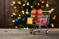 PhotoStock Mini shopping cart with gift box, festive shopping concept Royalty Free Stock Photo