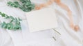 Photostock wedding styled composition. Feminine desktop mockup scene with eucalyptus leaves, silk ribbon, blank brown greeting car