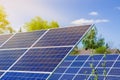 Photovoltaic ecological modules on green grass valley against of sun and cloudy sky Royalty Free Stock Photo