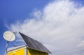 Photovoltaic modules and antenna on the roof of a house Royalty Free Stock Photo