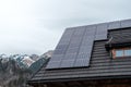 Photovoltaic panels on the roof of a mountain hut. Mountains in the background Royalty Free Stock Photo