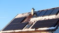 Photovoltaic panels vs. thermal solar panels. Energy production on the roof of the house. Royalty Free Stock Photo