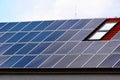 photovoltaic PV sun collector solar panels on sloped residential clay roof. sunshine and blue sky. Royalty Free Stock Photo