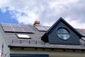 Photovoltaic solar panels installed on sloped metal roof. blue sky.