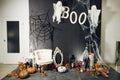 Photozone with pumpkins, candles, scary ghost and cobweb for Halloween party