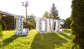 Photozone. Wedding decor. Large white letters with the inscription love on the green grass. Valentine`s Day.