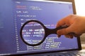 PHP back-end code zoomed through a magnifier. Computer programming source code lookup. Abstract screen of web developer Royalty Free Stock Photo