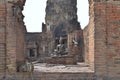 Seated Buddha in brick annex to the east of central tower of Phra Prang Sam Yod & its resident macaques, Lopburi, Thailand