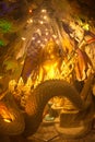 Phra Rattana Mahabadan and the guardian serpent in the Naga cave at Wat Maniwong Temple.