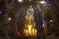 Phra Rattana Mahabadan and the guardian serpent in the Naga cave at Wat Maniwong Temple.