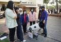 The trainees are studying how to use a reflective telescope with Alt-azimuth mount in an astronomical workshop.