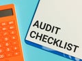 Phrase AUDIT CHECKLIST written on paper clipboard Royalty Free Stock Photo