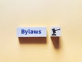 Phrase bylaws written on wooden block with gavel icon. Royalty Free Stock Photo