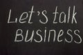 The phrase on a chalk board `Lets talk business`