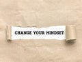 Phrase CHANGE YOUR MINDSET appearing behind torn brown paper. Royalty Free Stock Photo