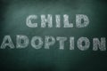 Phrase Child Adoption written with chalk on board