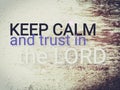 Short message saying Keep calm and trust in the Lord.  Text on wood background saying keep calm and trust in the Lord. Royalty Free Stock Photo