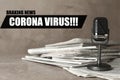 Phrase Corona Virus, newspapers and vintage microphone on table. Journalist`s work Royalty Free Stock Photo