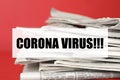 Phrase Corona Virus and stack of newspapers on background, closeup. Journalist`s work Royalty Free Stock Photo