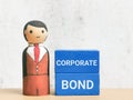 Phrase CORPORATE BOND on blue wooden cubes with businessman doll Royalty Free Stock Photo
