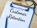 Phrase CUSTOMER RETENTION written on paper clipboard