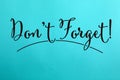 Phrase Don`t forget written on blue paper Royalty Free Stock Photo