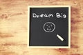 The phrase dream big written on chalkboard