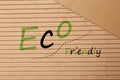 Phrase Eco Friendly written on cardboard, top view