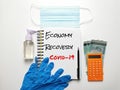 Phrase Economy Recovery Covid-19 on note book with rubber hand glove,sanitizer bottle,mask,pen,calculator and money. Royalty Free Stock Photo