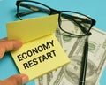 Phrase ECONOMY RESTART written on sticky note