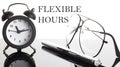 The phrase FLEXIBLE HOURS with alarm clock, glasses and pen