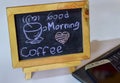 Phrase Good Morning coffee written on a chalkboard on it and smartphone, laptop Royalty Free Stock Photo