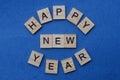 Phrase happy new year made from gray wooden letters